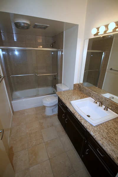 Remodeld Full bathroom with granite counters and Travertine floors