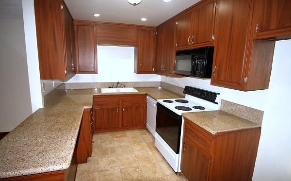 Fully equipped kitchen with custom cabinets and Travertine Tile