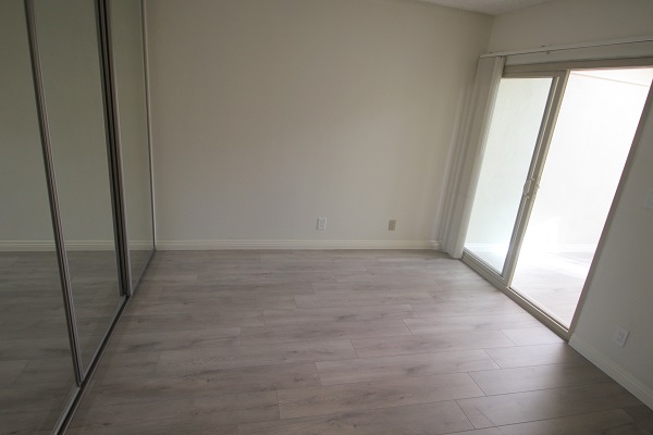 Large second bedroom with wall to wall mirrored closets